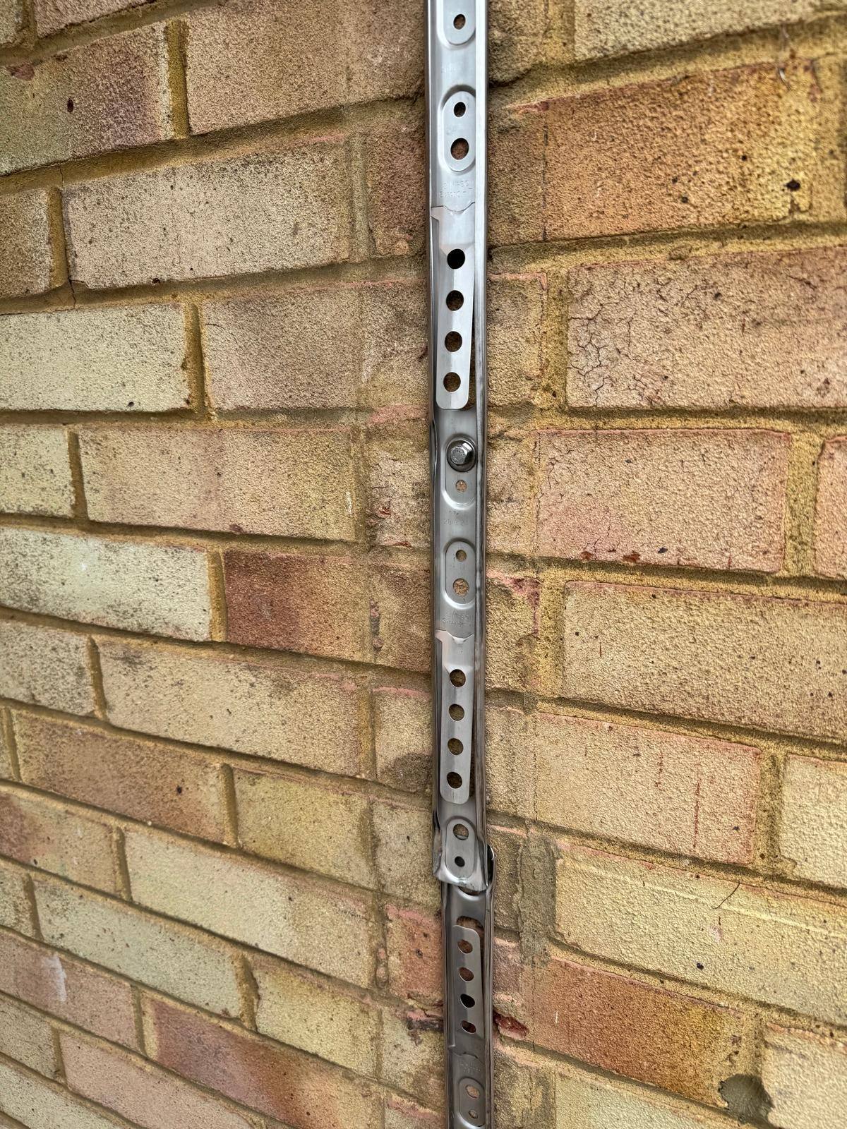 Stainless steel starter ties fixed to host wall