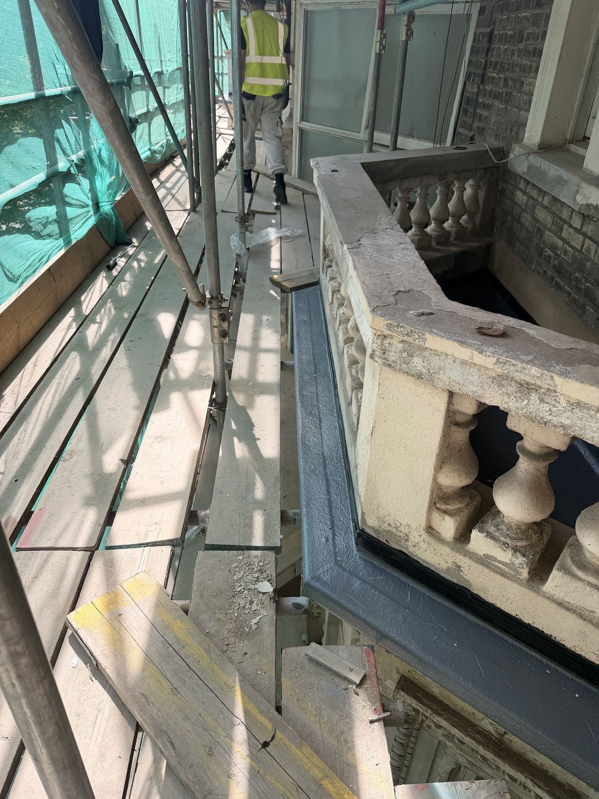 Cast stone balcony balustrade under repair
