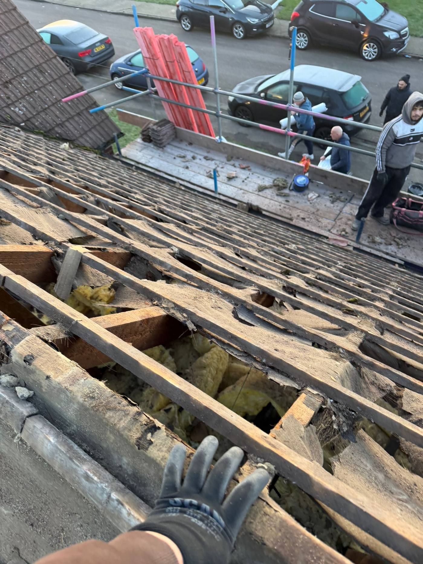 Strip out of existing roof covering revealing degraded felt and battens