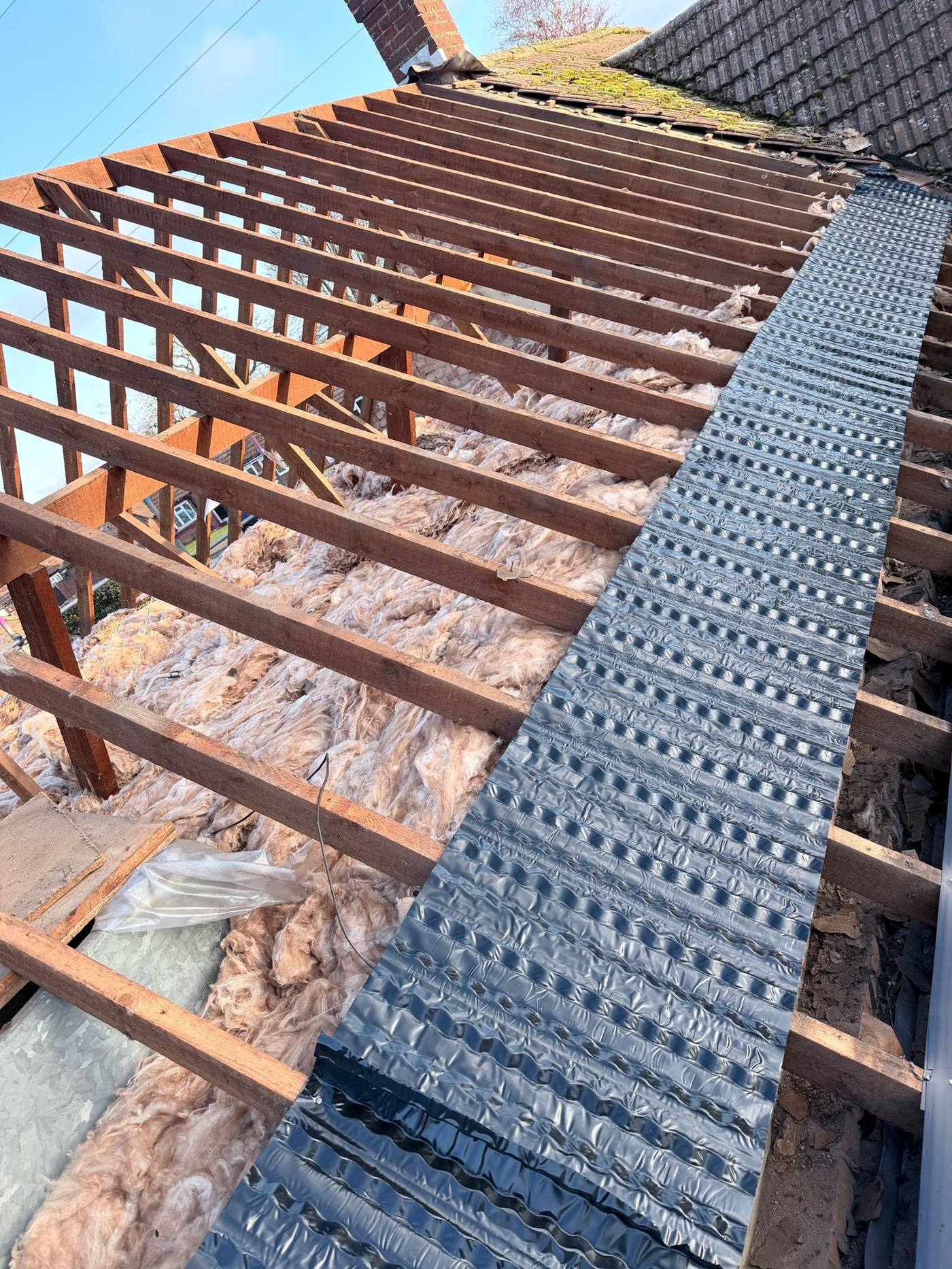 Completed roof slope with renewed chimney flashing