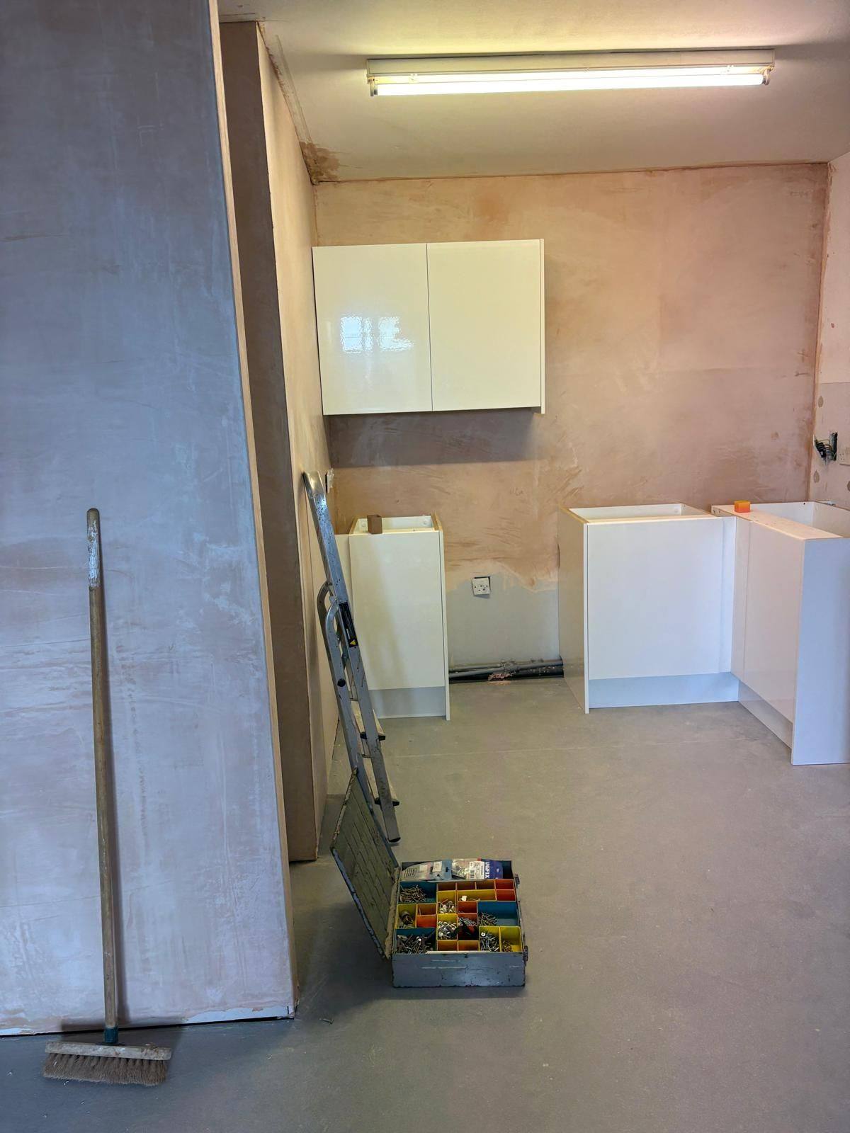 Walls plastered and new kitchen units being installed