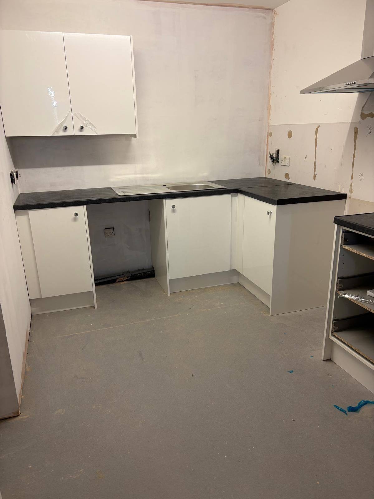 Completed kitchen with new units, worktop, sink and extraction